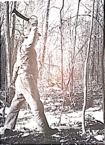 A black and white image of a man swinging the Woodman’s Pal