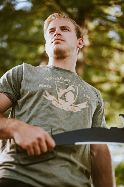Man outdoors holding the leather-handle Woodman's Pal machete