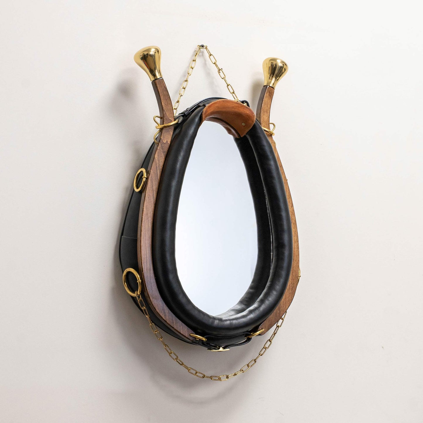 Three-quarter angle view of Amish horse collar mirror highlighting depth and brass details