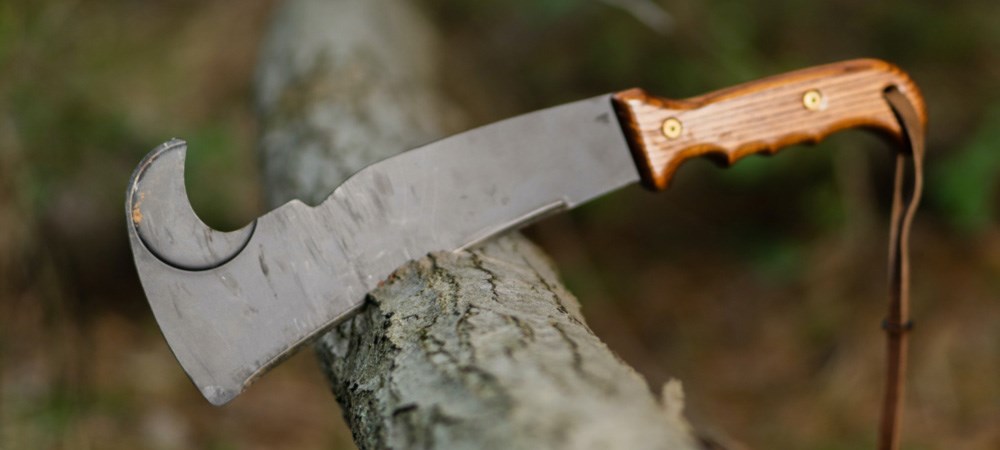 A Woodman’s Pal land management tool cutting into a tree branch.